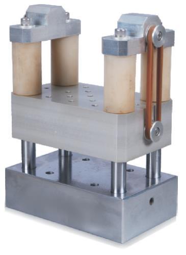 Dual-mass shock amplifier with a square specimen mounting table. Representative catalog photograph.