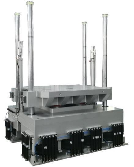 Vertical shock test machine with a mounting table and guide columns. Representative catalog photograph.
